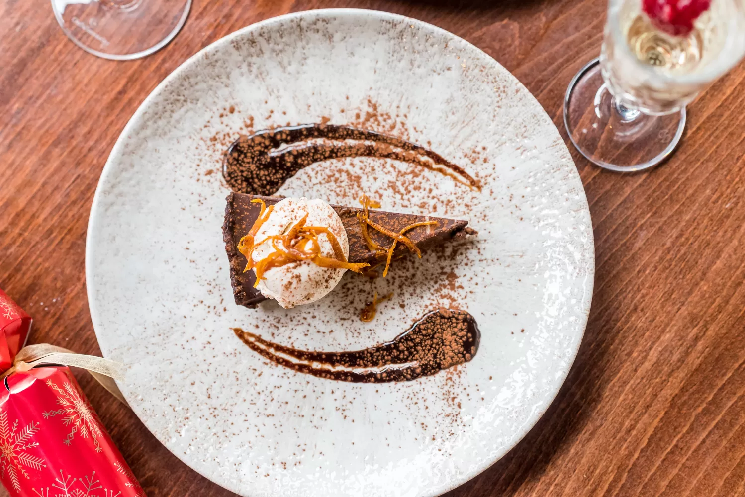 Birdseye view of a chocolate tart and Christmas cracker served at 62 The Bank in North Devon