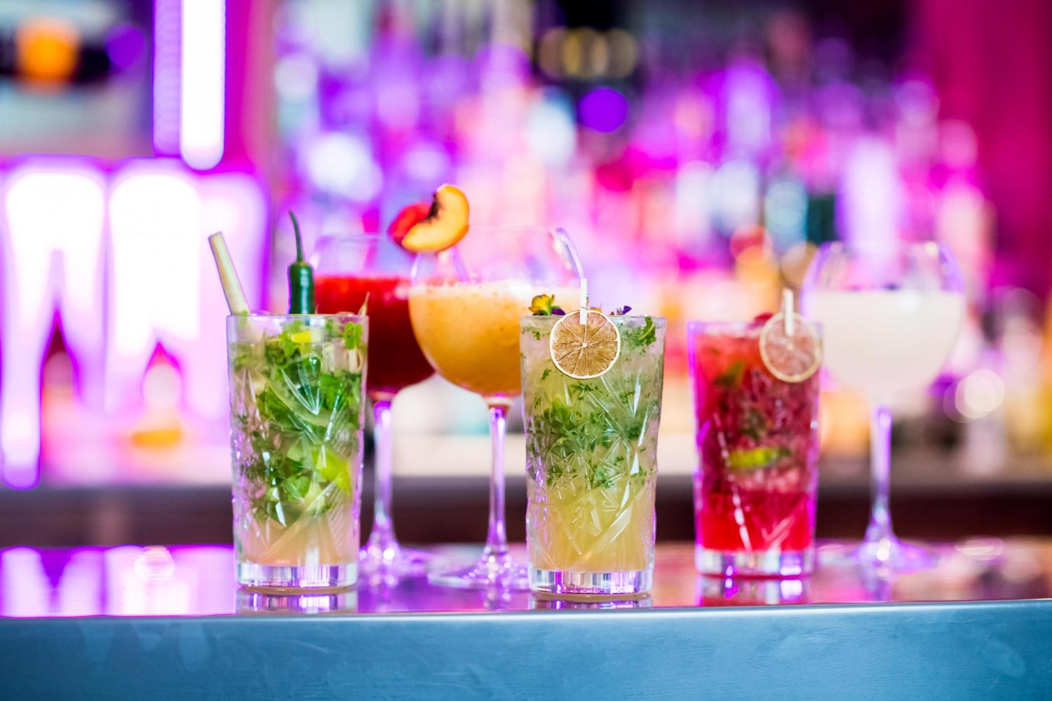 A selection of freshly made cocktails sitting on the bar