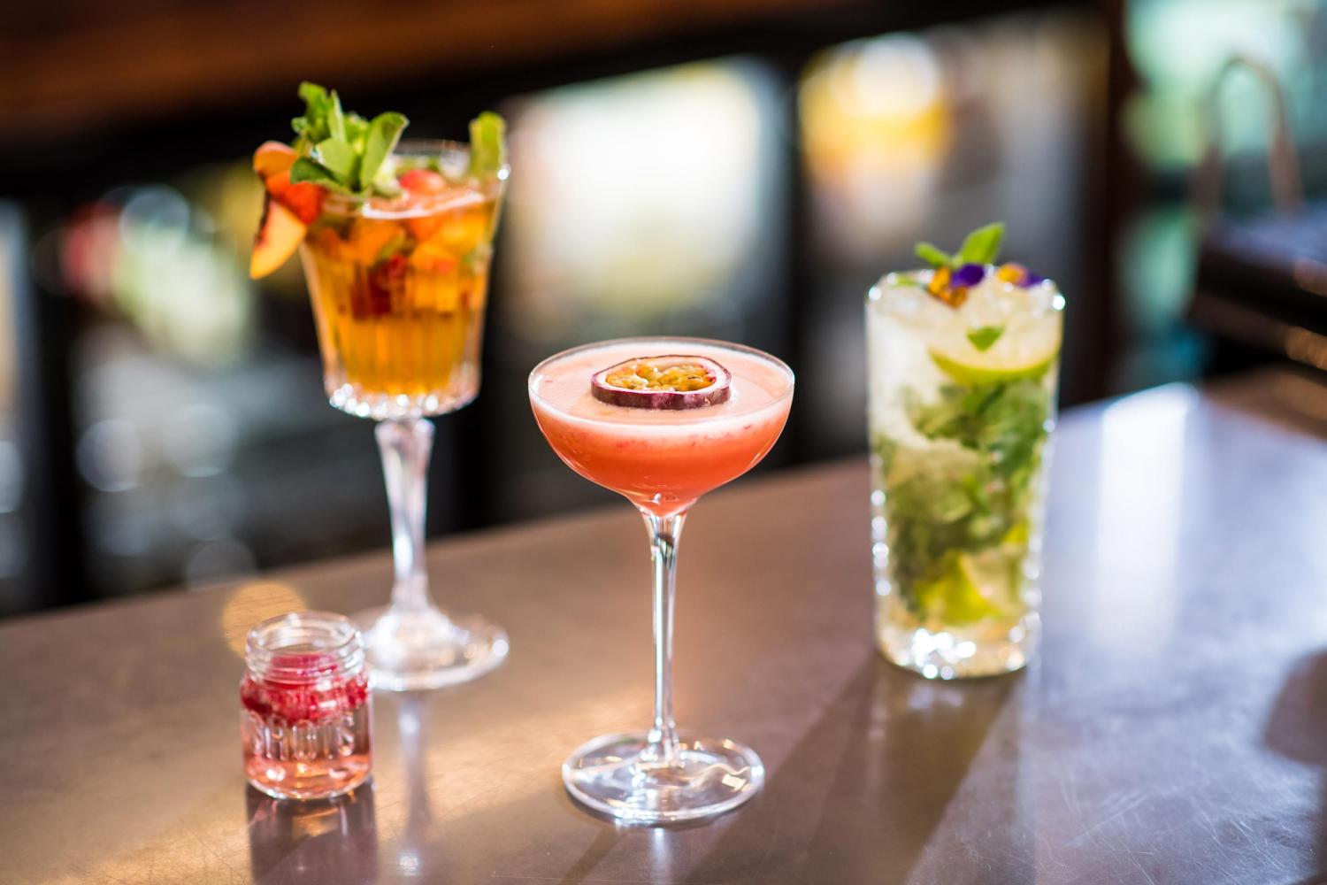 A close up of freshly prepared cocktails resting on the bar