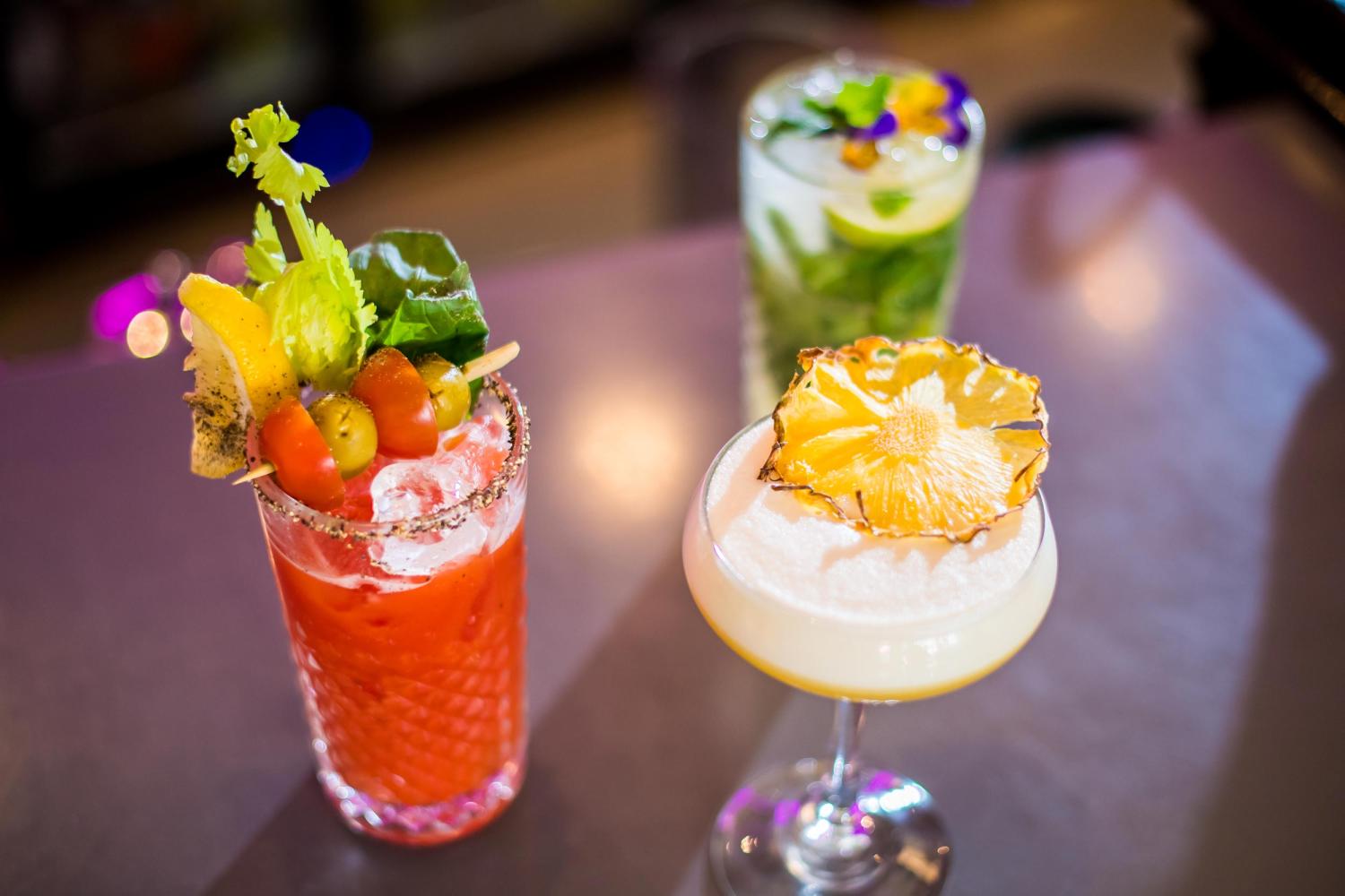 A selection of freshly made cocktails sitting on the bar