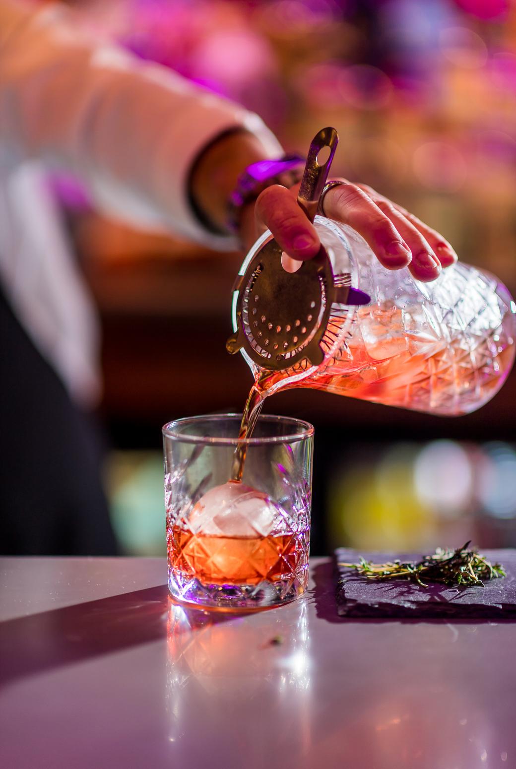 Pouring Cocktail into ice glass