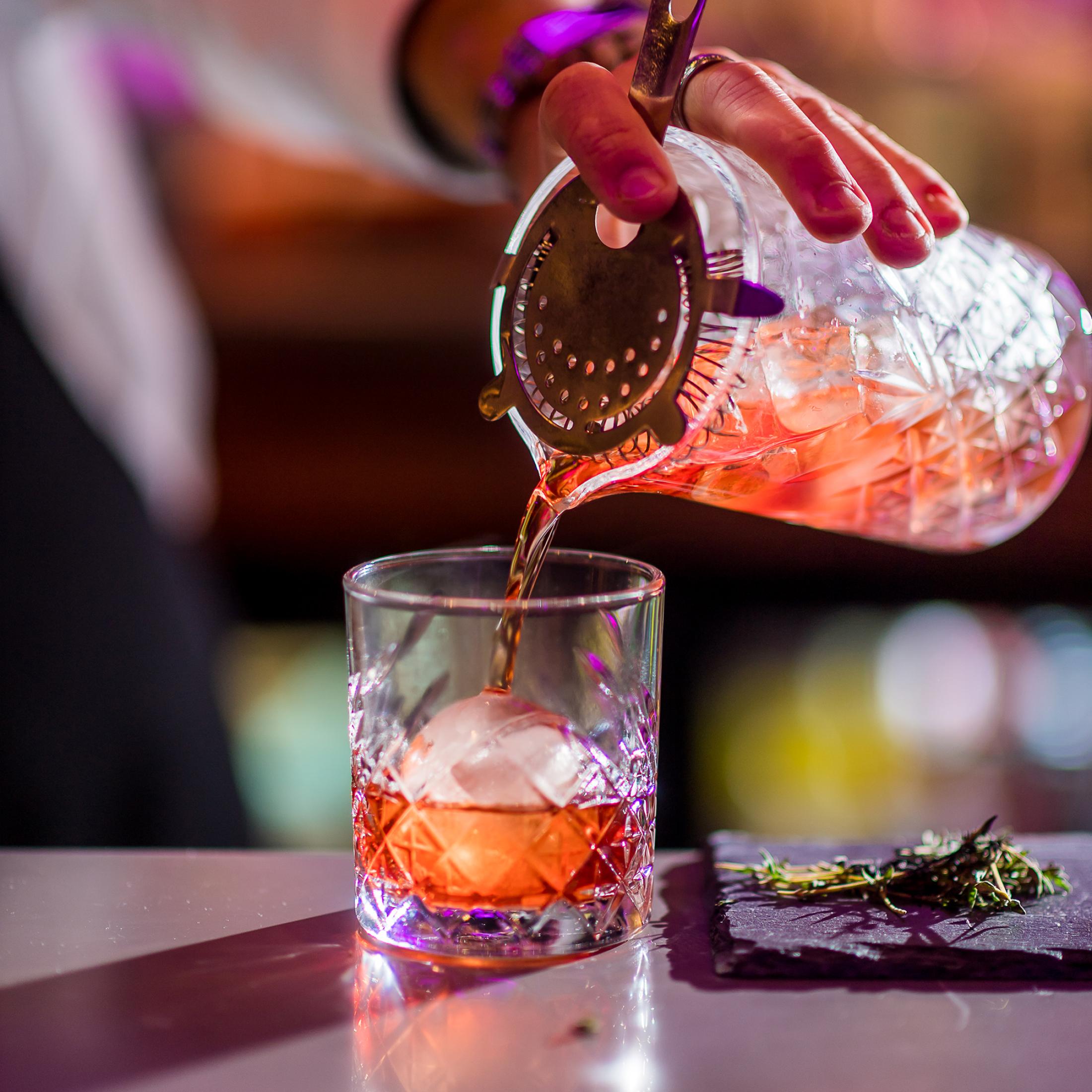 Pouring Cocktail into ice glass