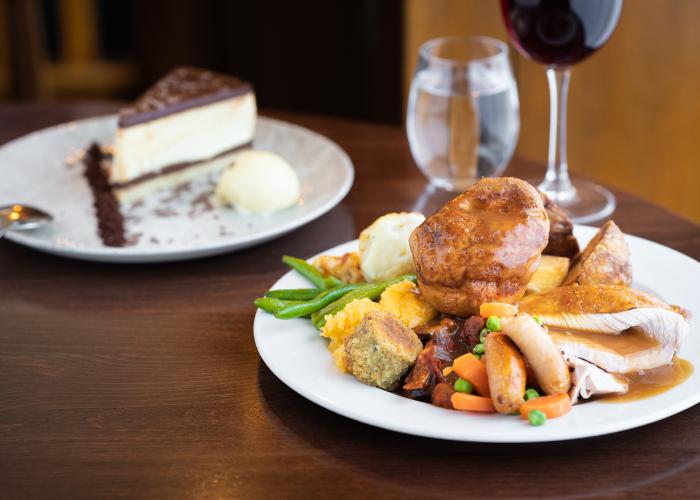 A large Sunday carvery plate containing roast turkey, Yorkshire Pudding, vegetables, potatoes and gravy 