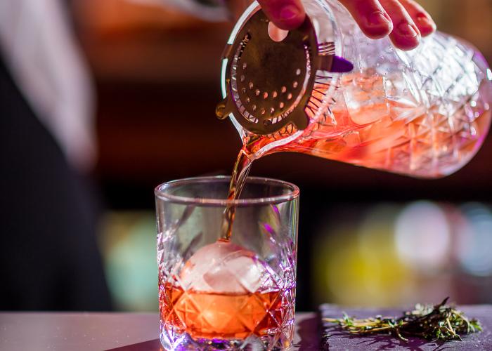 Pouring Cocktail into ice glass